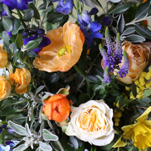 A bright, blue & beautiful bouquet with a golden touch, guaranteed to make an impact on Mother’s Day. Created with golden garden roses mixed with a Spring selection of muscari, narcissi, iris and ranunculus along with delphiniums, buttercups, Icelandic poppies, sandersonia & mimosa.