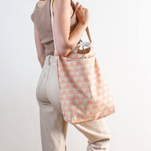 woman wearing palm print bag from cai & jo